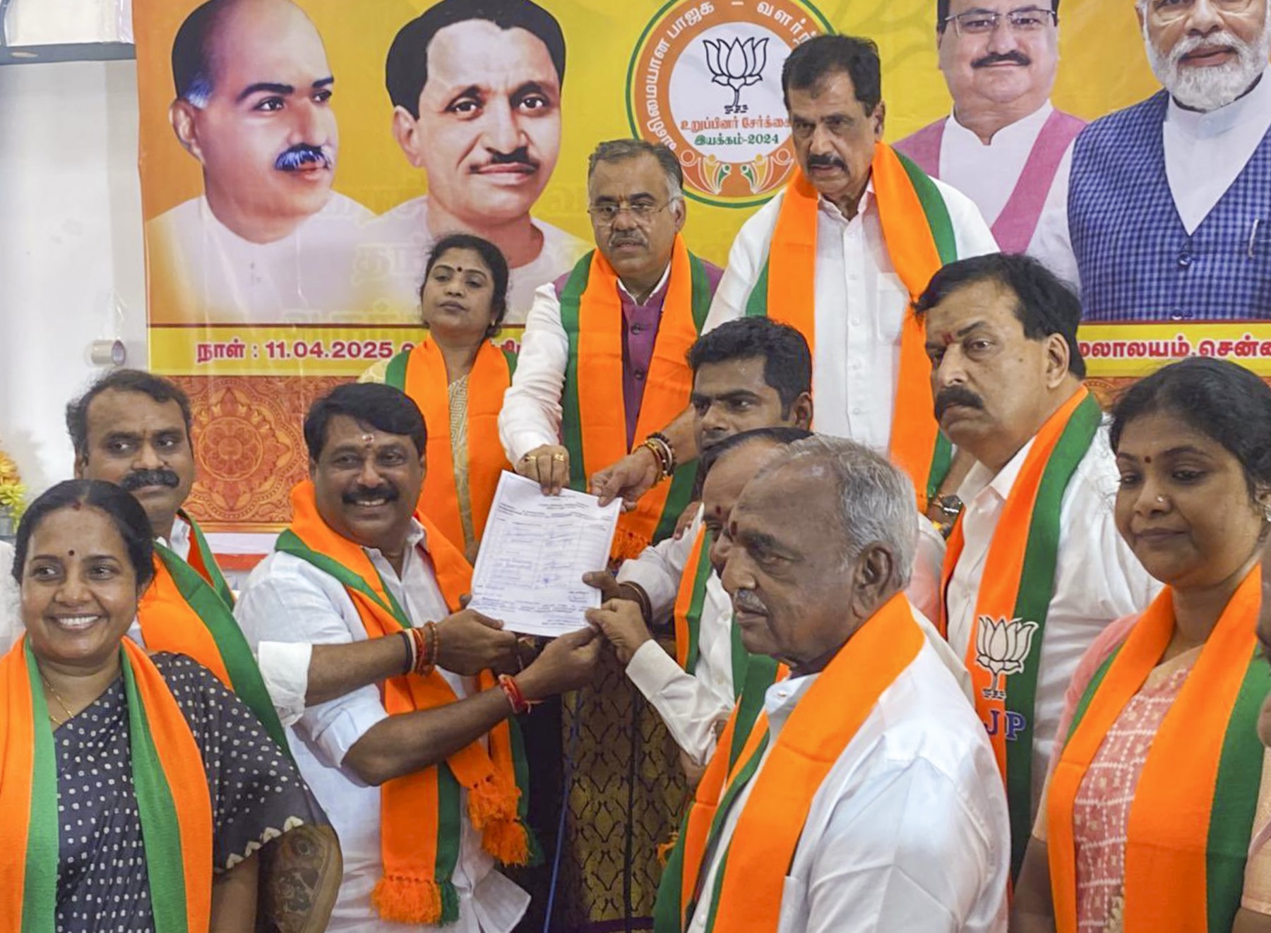 Nainar Nagendran and party office-bearers holding a nomination paper at the BJP Tamil Nadu headquarters, beneath a banner dated 11 April 2025